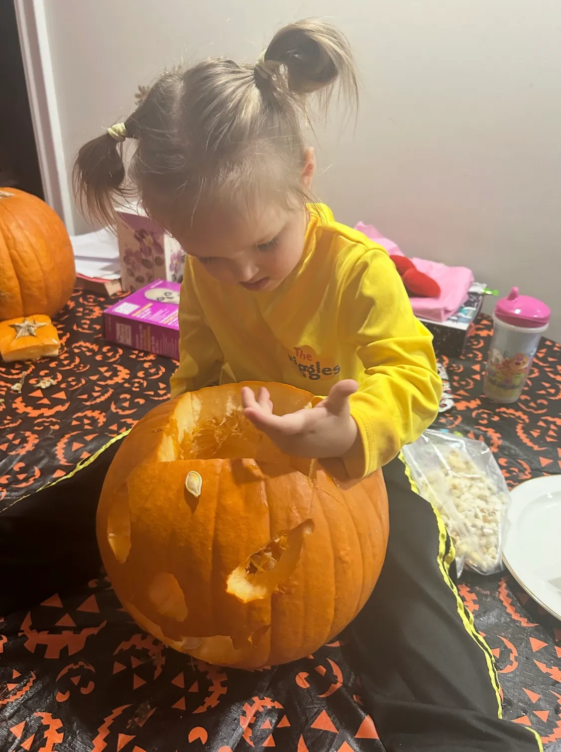 Photo of daycare kid taking out pumpkin seeds